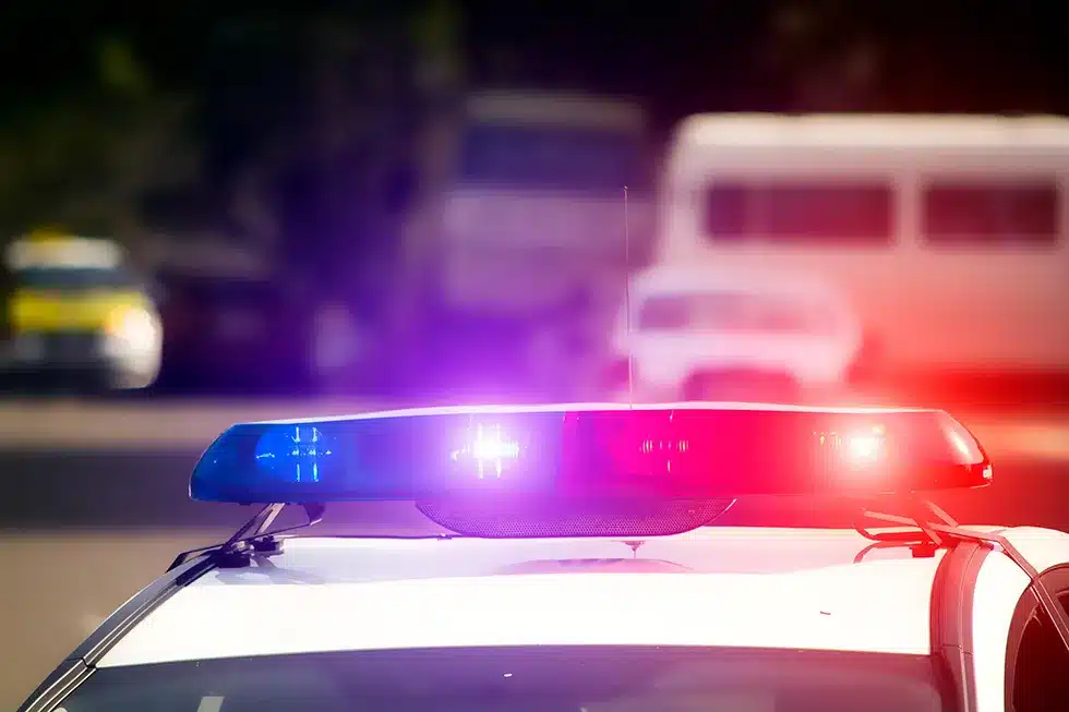 Police lights on a police car parked  behind a drunk driver who is calling his Harrisburg DUI attorney.