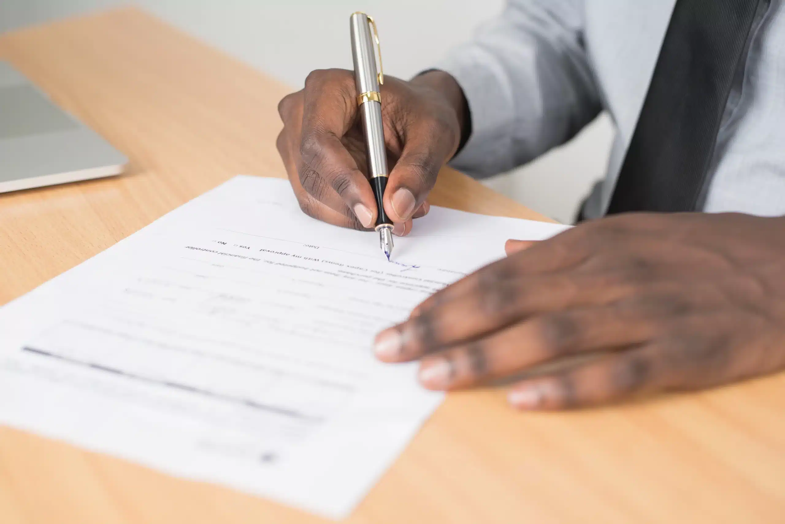 Someone reviewing and signing paperwork. 