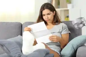 Injury victim reviewing medical bills.