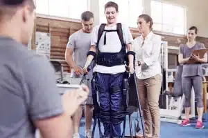 A man recovering from a spinal cord injury with a PT