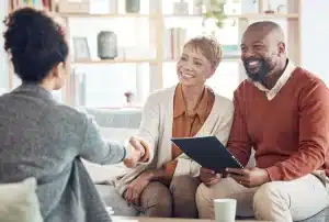 An elderly couple speaking with an estate attorney.