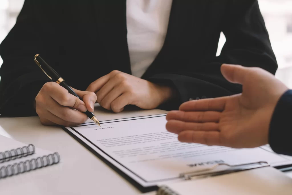 A person signing business documents, representing legal guidance from an LLC formation lawyer in Pennsylvania.
